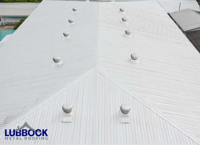 White metal rooftop with multiple ventilation vents